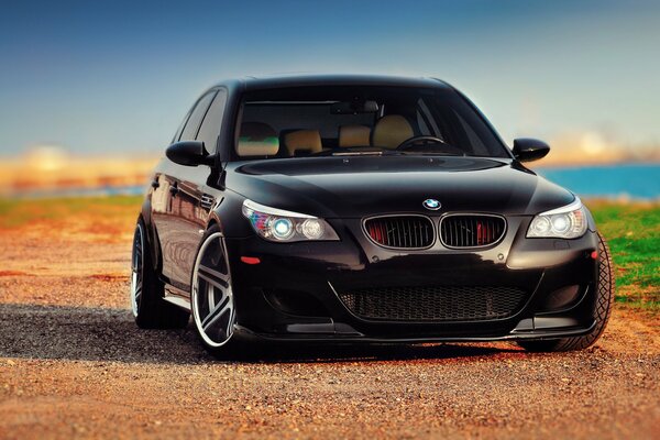 BMW black e60 by the sea