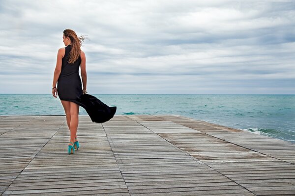 Long legs on a gray pier