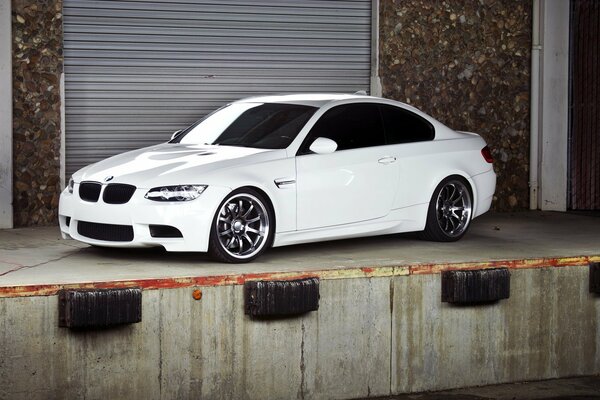 White BMW side view in the garage