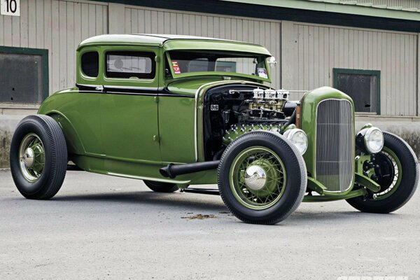 Green ford hod rod without hood with open engine