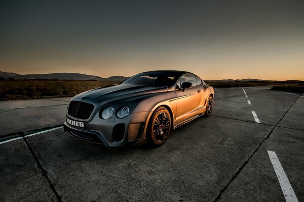 Car on dorosh at sunset, Bentley continental in the evening