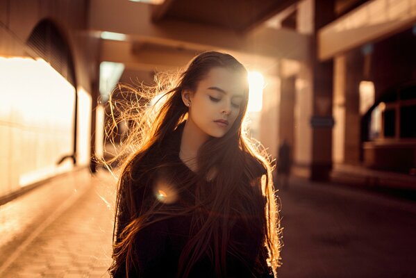 A girl with long hair in the sunlight