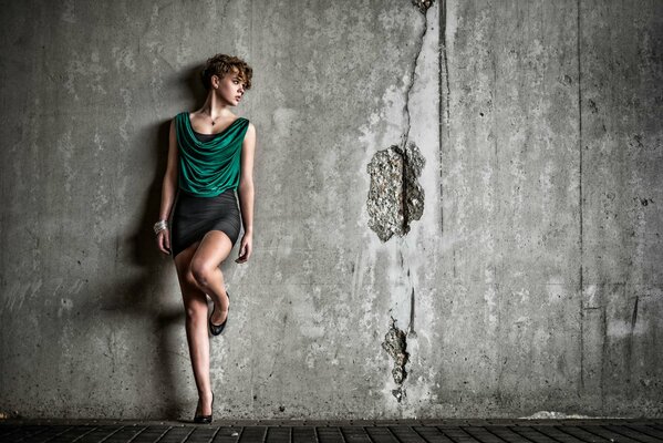 Beautiful model on a gray wall background