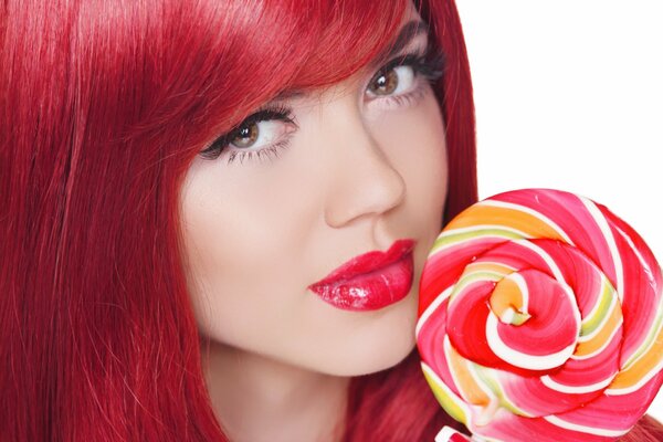 Girl with red hair with a big lollipop