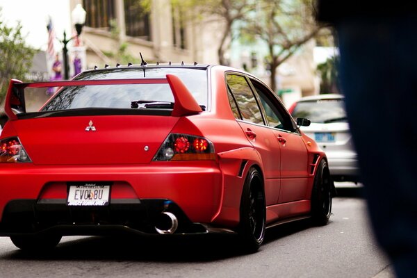 Mitsubishi red sports in traffic