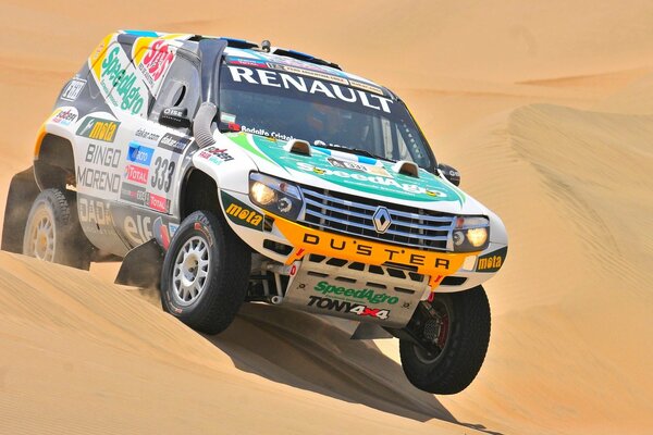 A sport utility vehicle participates in a rally in the desert