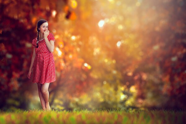 A girl in a red dress in autumn