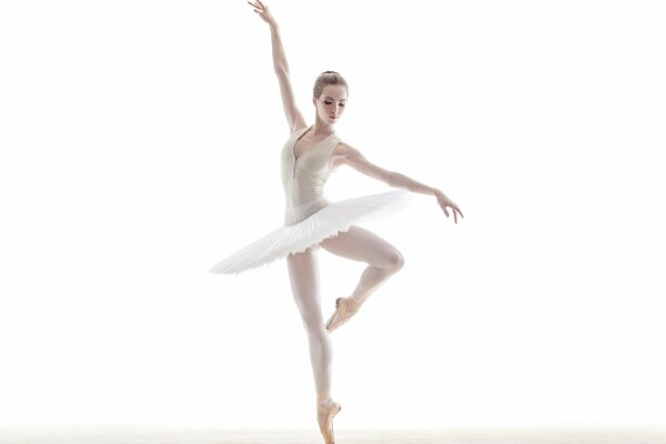 Ballerina in a white tutu on a white background