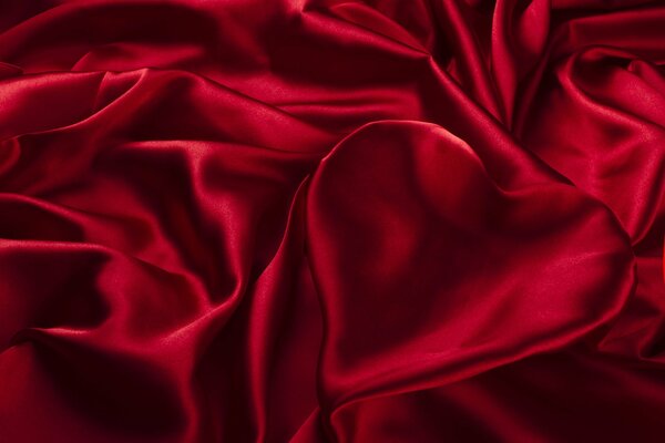 Heart made of red silk fabric with pleats