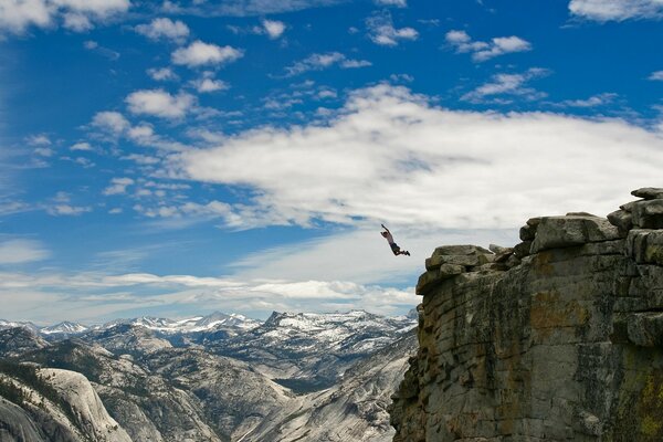 A running jump from a cliff into the abyss