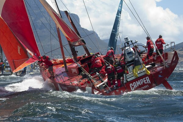 People on a red yacht in the middle of the ocean