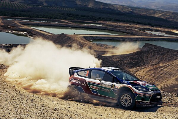 Racing car drifts raising dust