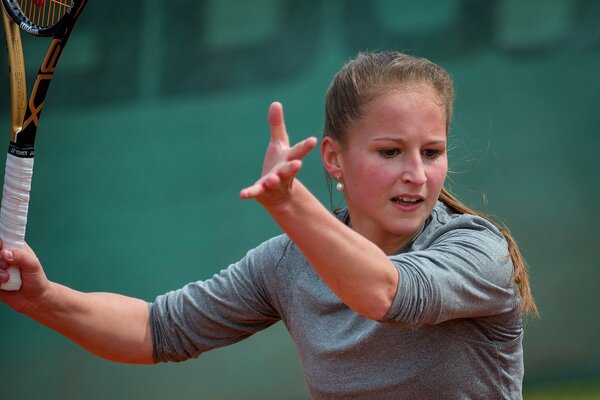 A tennis player with a racket in her hand during a game