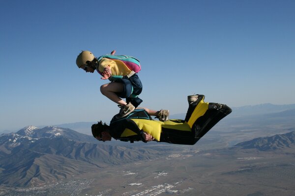 Extreme skydivers perform a trick