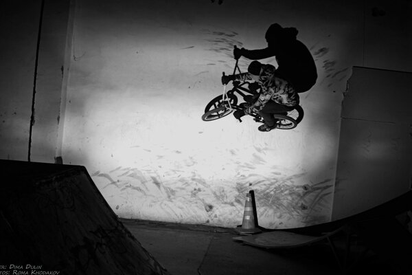 Black and white photo of a guy in a skatepark