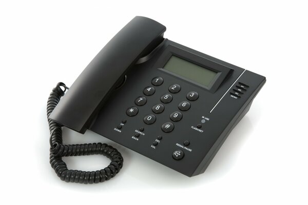 Black office phone on a white blank background