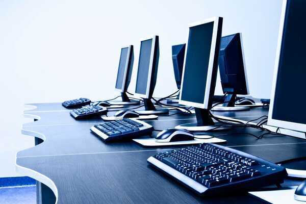 A row of computers on a table in the club