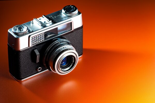 Kamera-Klassiker auf orangefarbenem Hintergrund