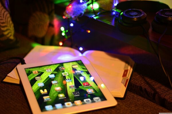 The picture on the table is a book with a tablet and a garland