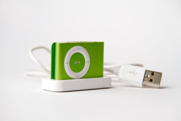 Apple player in a green case with a usb cable