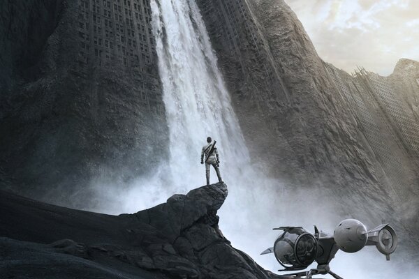 A shot from a movie with Tom Cruise on the background of a waterfall