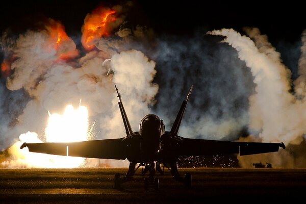 Explosions behind a powerful fighter