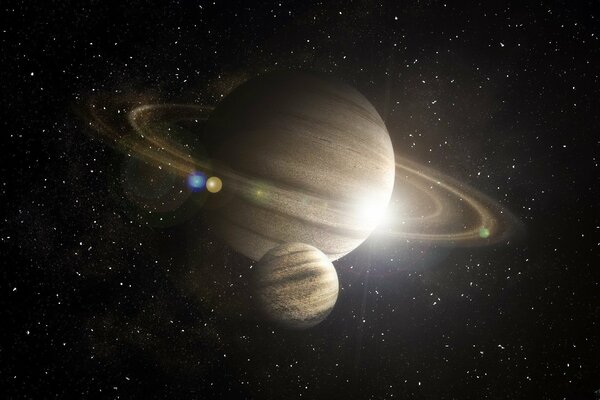 Saturno con la sua luna sullo sfondo delle stelle