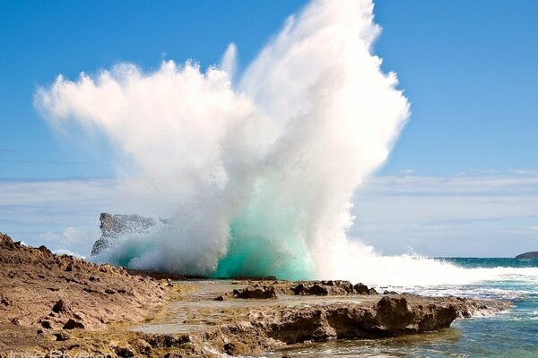 The impact of a wave on a rocky ledge
