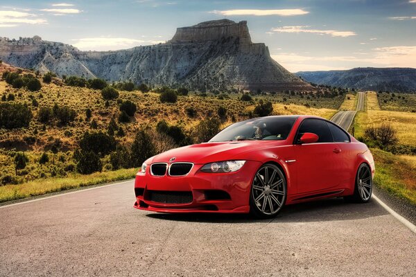 Red tuned BMW in the mountains