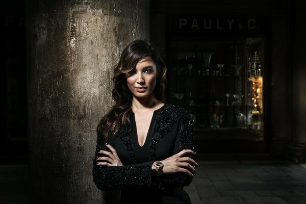 Berenice Marlowe in black clothes on a black background