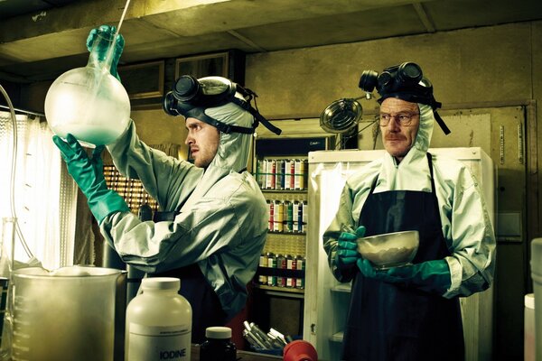 Two men in special suits conduct experiments