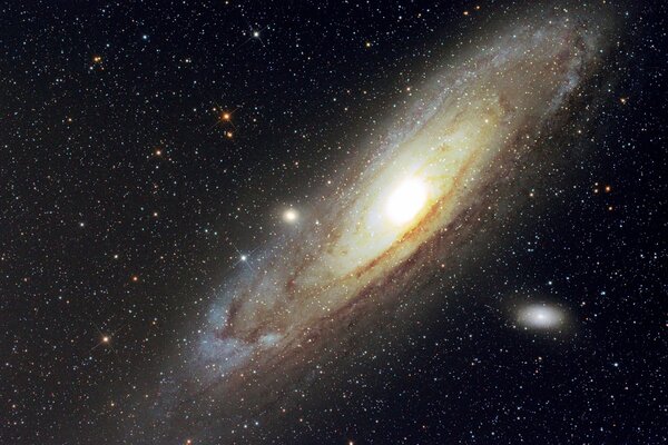 Andromeda galaxy glows on a dark background