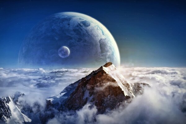 The peak of the mountain is above the clouds near the planet