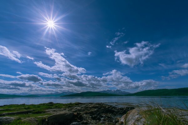 The sky and the sun are reflected in the lake