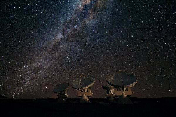 Radiotelescopi sullo sfondo della Via Lattea e delle stelle