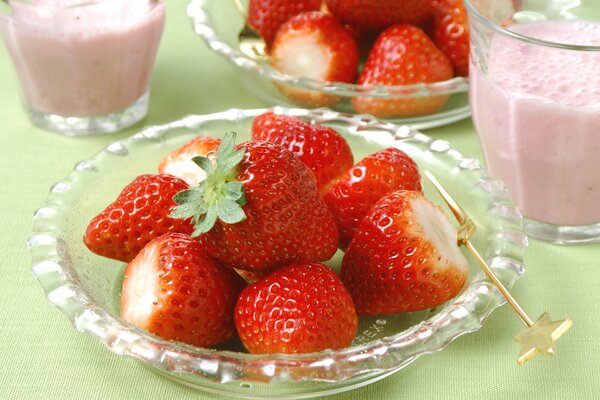 Delicious strawberry on a plate and a smoothie in addition