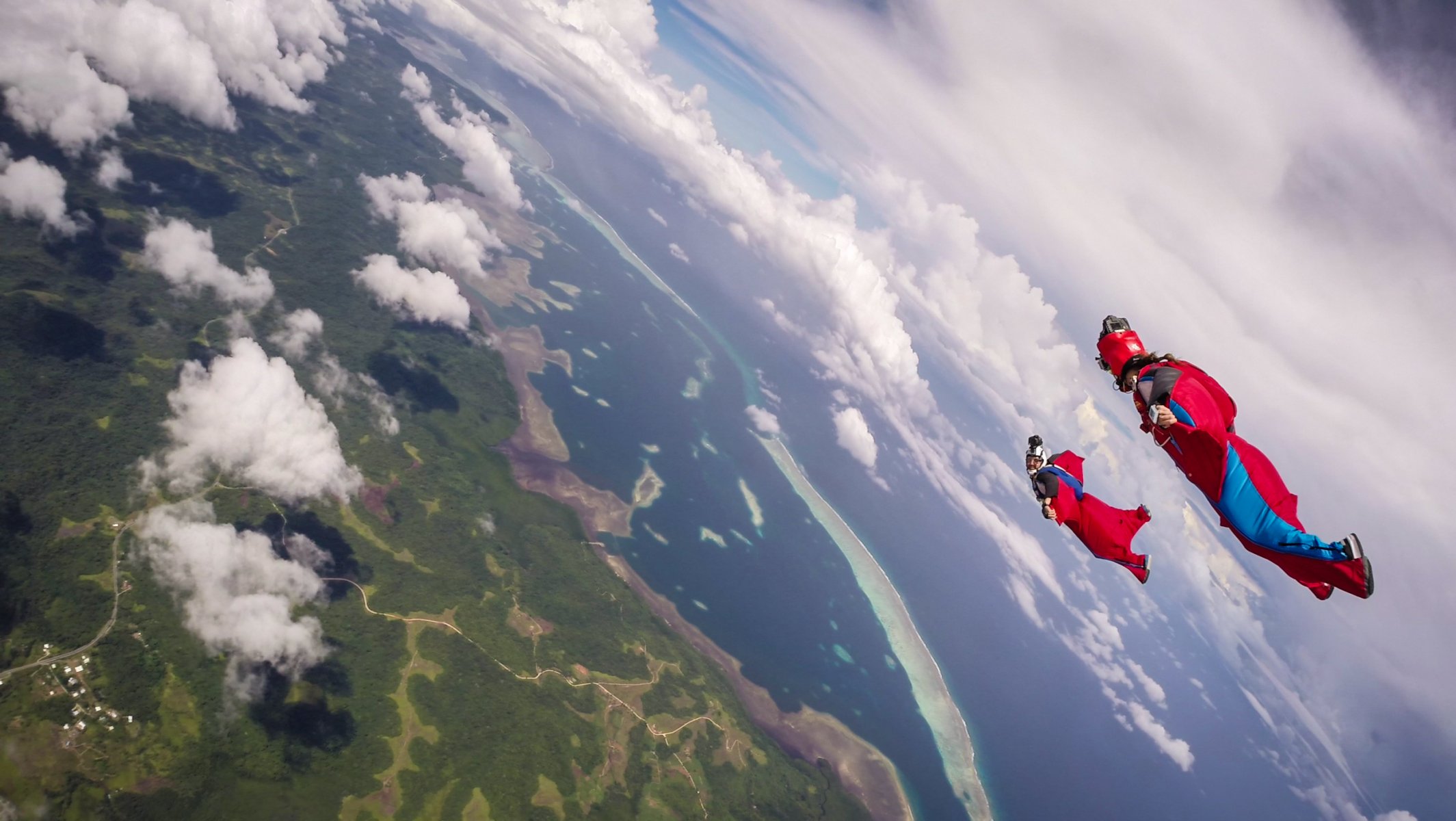 wingsuit drivers formation helmet camera clouds shadow sea island trailers parachute extreme sport