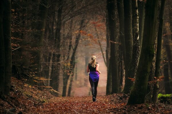 A girl who went for a run in the autumn forest