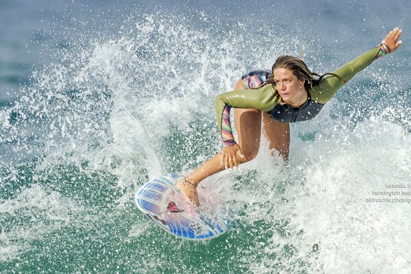 A woman on a board catches a wave