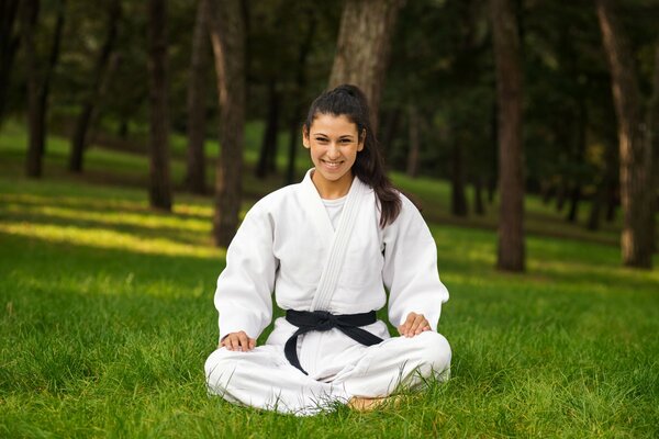 Miroslava Dzotova in a kimono with a black belt in nature