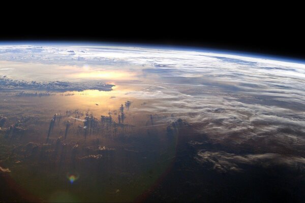 View of the planet s atmosphere with clouds and water