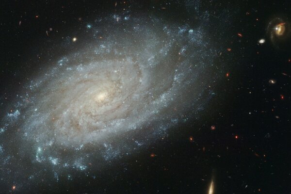 Galactic spiral on a dark background surrounded by stars