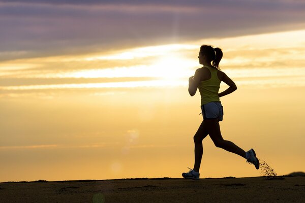 The athlete runs through mud and sand