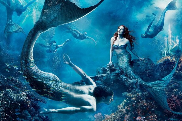 Mermaids with tails and fish in the ocean depths