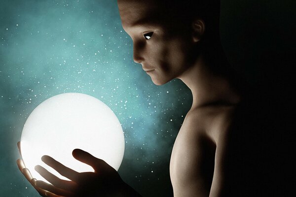 A glowing ball in the hands of an alien