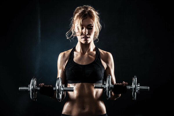 Fitness with dumbbells and beauty