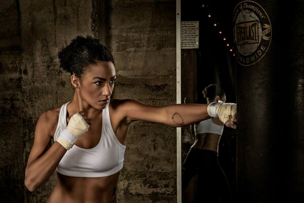 A girl trains with a punching bag