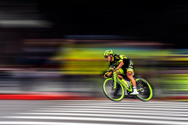 A sportsman on a neon bike participates in a race