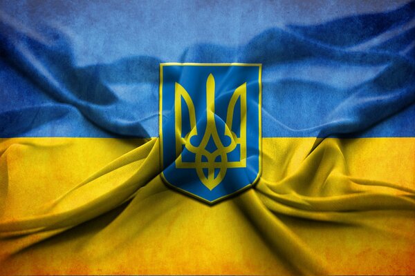 Die blau-gelbe Flagge der Ukraine und das Wappen der Ukraine auf der Flagge