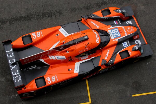 Racing orange car on asphalt background